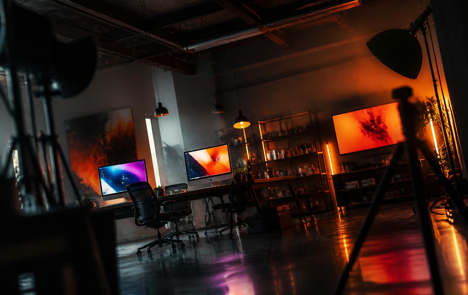 Dark creative studio with colour-graded screens and cinematic lighting equipment